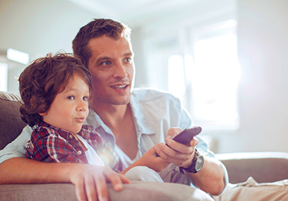 Father and son watching football