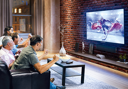 Four adult men watching Ice hockey game on TV